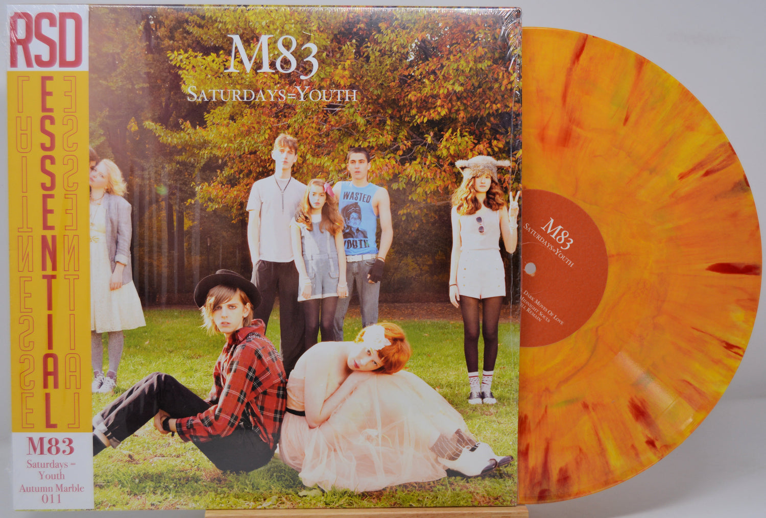Vinyl record with a colorful cover featuring a group of people outdoors, labeled 'M83 Saturdays Youth'.