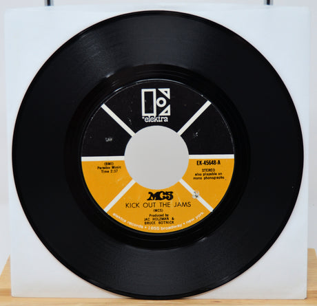 Black vinyl record with a yellow label on a white background