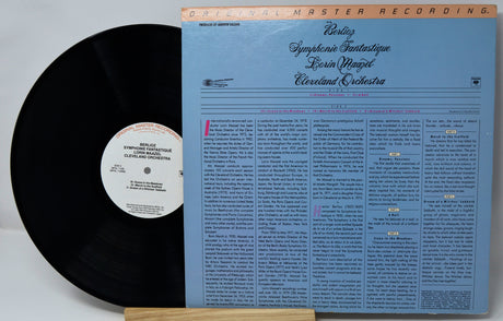 Vinyl record with blue cover and black disc on a white background