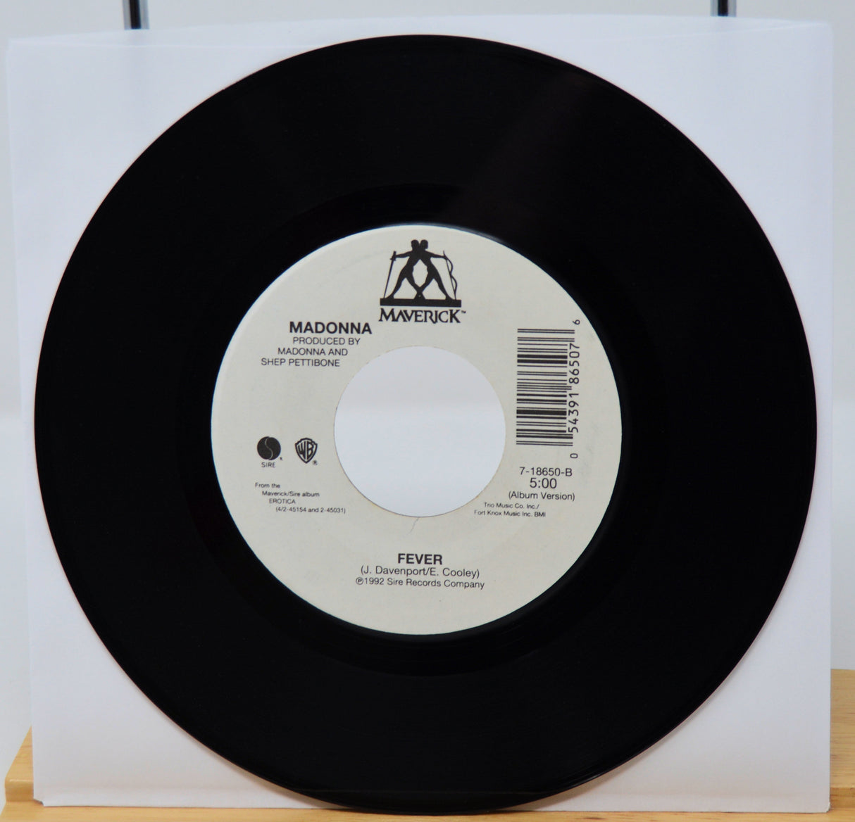 Vinyl record with a white label featuring 'Maverick' and 'Madonna' on a white background.