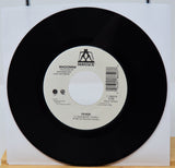 Vinyl record with a white label featuring 'Maverick' and 'Madonna' on a white background.