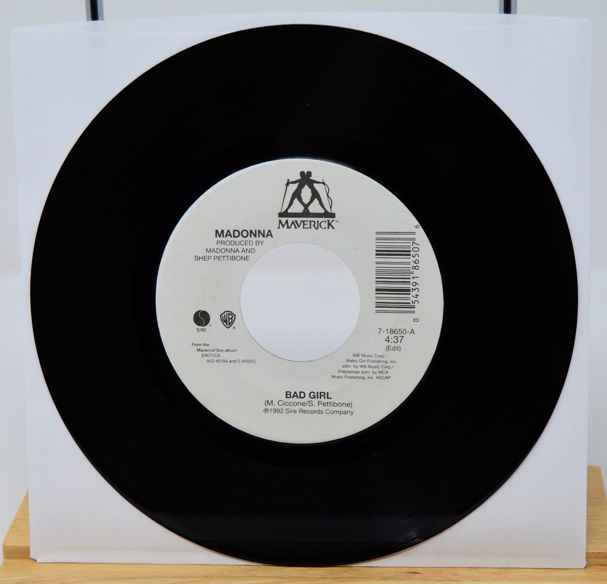 Vinyl record with a white label featuring 'Maverick' and 'Warner Bros.' logos on a white background.