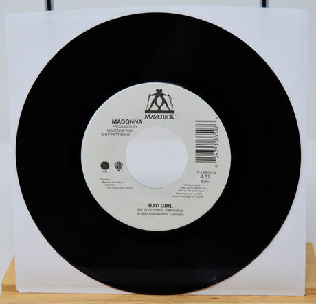 Vinyl record with a white label featuring 'Maverick' and 'Warner Bros.' logos on a white background.