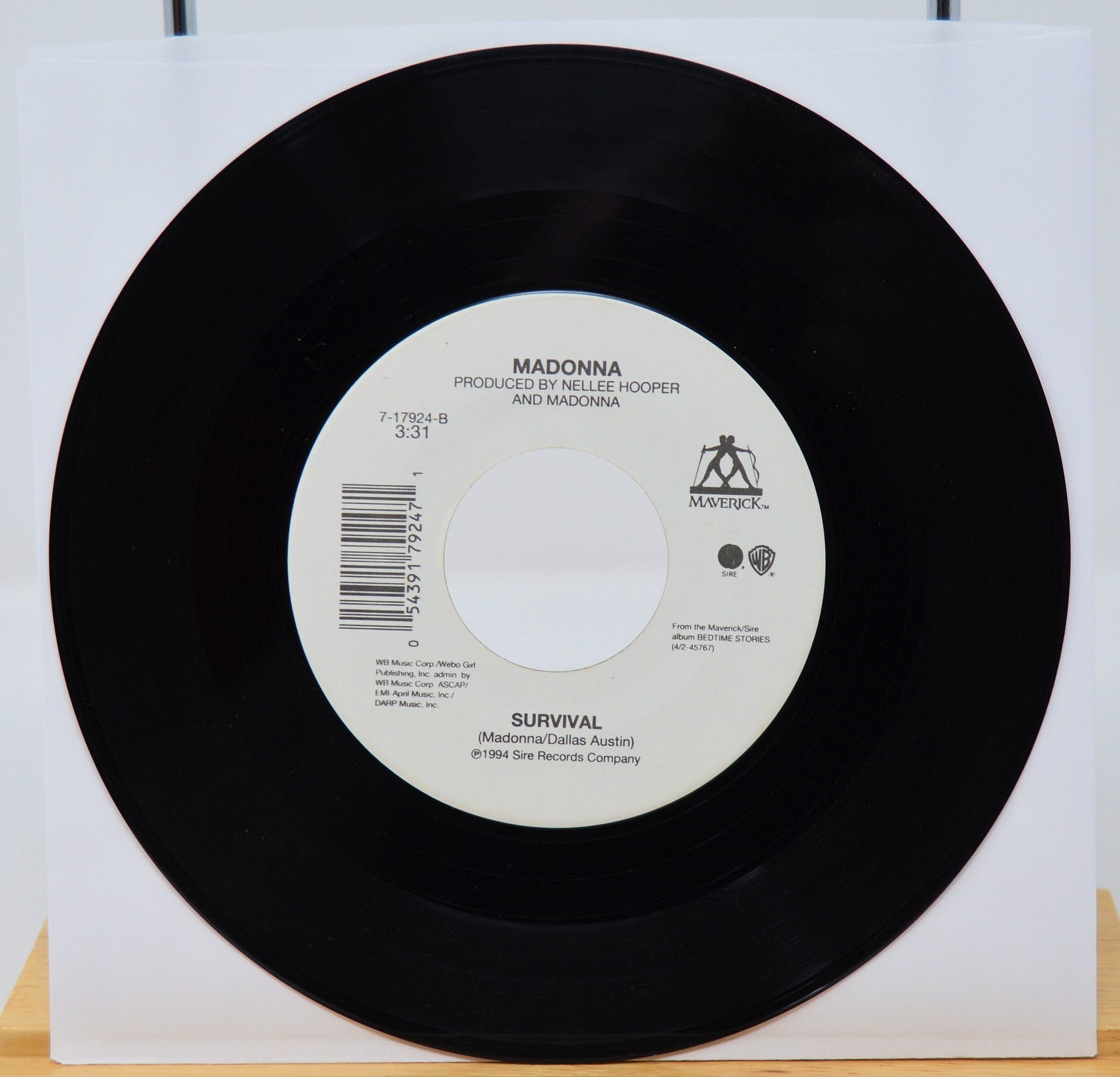 Vinyl record with label featuring 'Madonna' on a white background