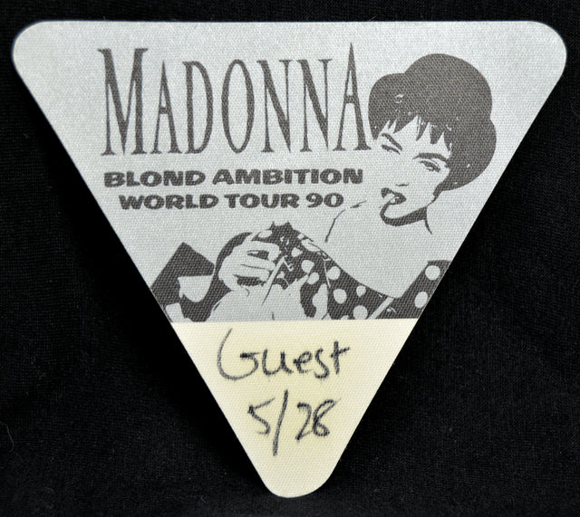 Triangular backstage pass for Madonna's Blond Ambition World Tour 90 with a black and white illustration of the artist.
