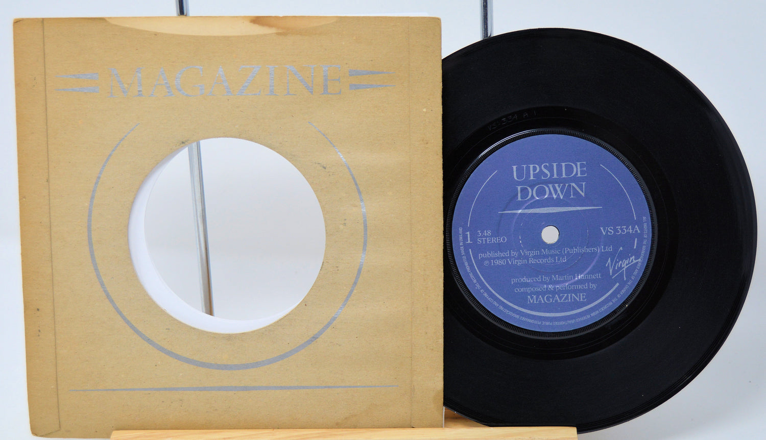 Vinyl record with 'Upside Down' label and magazine cover on a white background