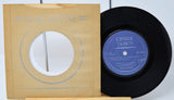 Vinyl record with 'Upside Down' label and magazine cover on a white background