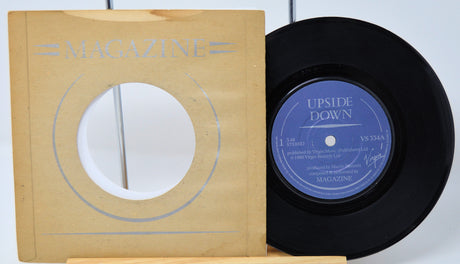 Vinyl record with 'Upside Down' label and magazine cover on a white background