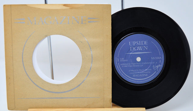 Vinyl record with 'Upside Down' label and magazine cover on a white background