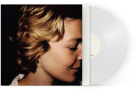 This image presents the physical album release of "Don't Forget Me" by Maggie Rogers, available as a vinyl record. The album cover features a close-up photograph of Maggie Rogers, capturing a serene and contemplative expression, which sets a emotional tone that is likely reflected in the album’s music.