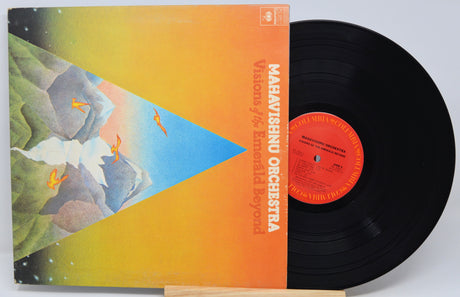 Vinyl record album for Marayehnu Orchestra's 'Vision for a Minimalist Future' with the illustrated cover standing beside the black LP and orange center label on a light background.
