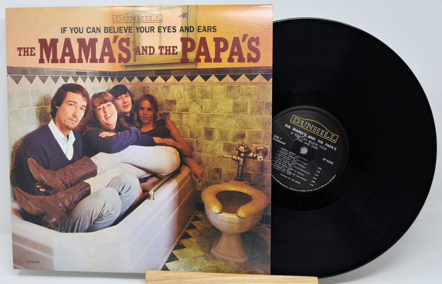 Vinyl record album 'The Mama's and the Papa's' by Brunswick, shown with the printed cover on the left and the black LP record partially visible on the right against a light gray background.