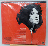 Vinyl record album cover for Steve Wonder's 'This Lady's Not Home Today' on a bright red background, wrapped in clear plastic and photographed from above.