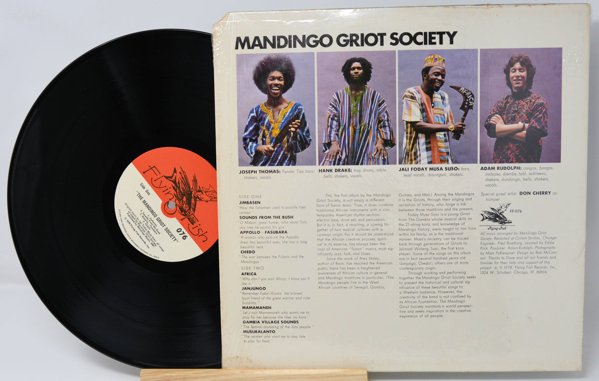 Vinyl record with 'Mandingo Griot Society' cover featuring four individuals.
