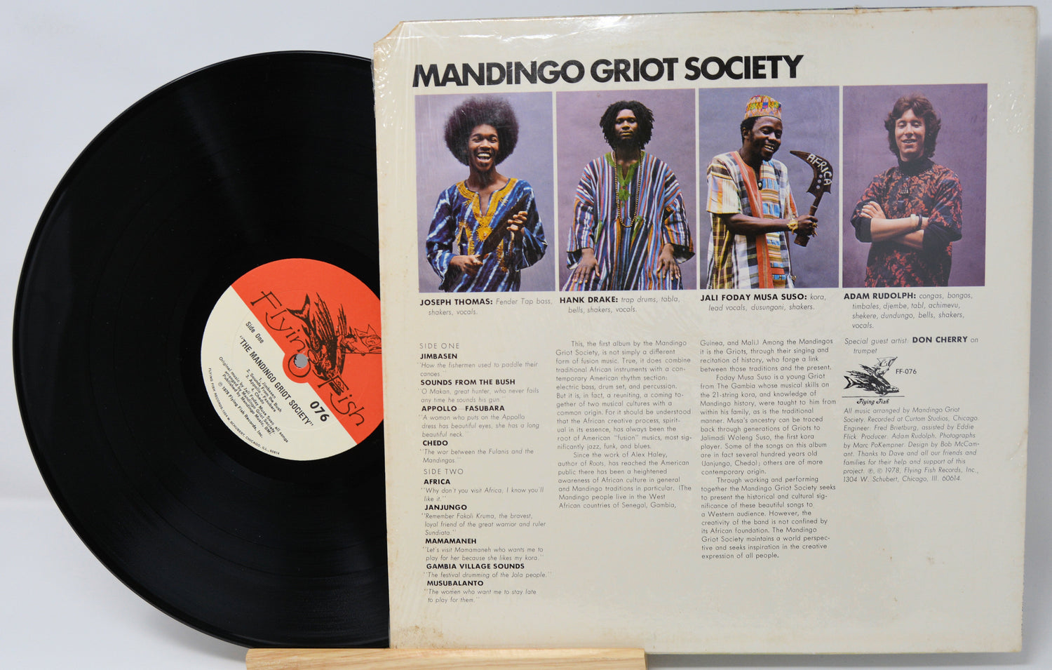 Vinyl record with 'Mandingo Griot Society' cover featuring four individuals.
