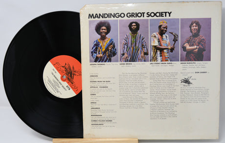Vinyl record with 'Mandingo Griot Society' cover featuring four individuals.