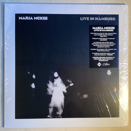 Front cover of Maria McKee Live in Hamburg vinyl LP showing dark stage performance lighting