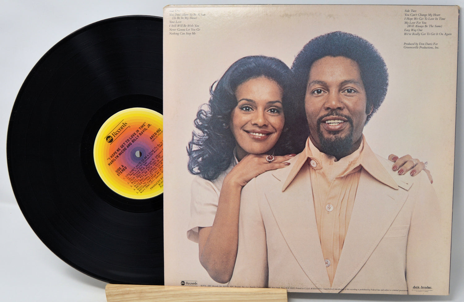 Vinyl record with cover featuring a couple on a white background