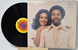 Vinyl record with cover featuring a couple on a white background