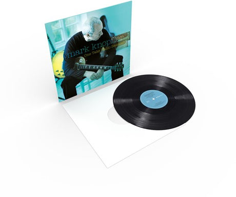 Vinyl record with cover featuring a person playing guitar on a white background