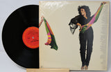 Vinyl record with a colorful cover featuring a person and text.