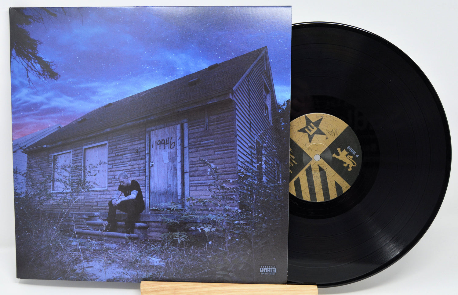 Eminem Marshall Mathers LP 2 album cover with vinyl record, Eminem in front of boarded Detroit house