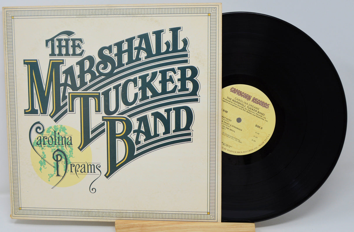Vinyl record and cover of 'Carolina Dreams' by The Marshall Tucker Band on a light gray background