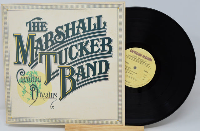 Vinyl record and cover of 'Carolina Dreams' by The Marshall Tucker Band on a light gray background