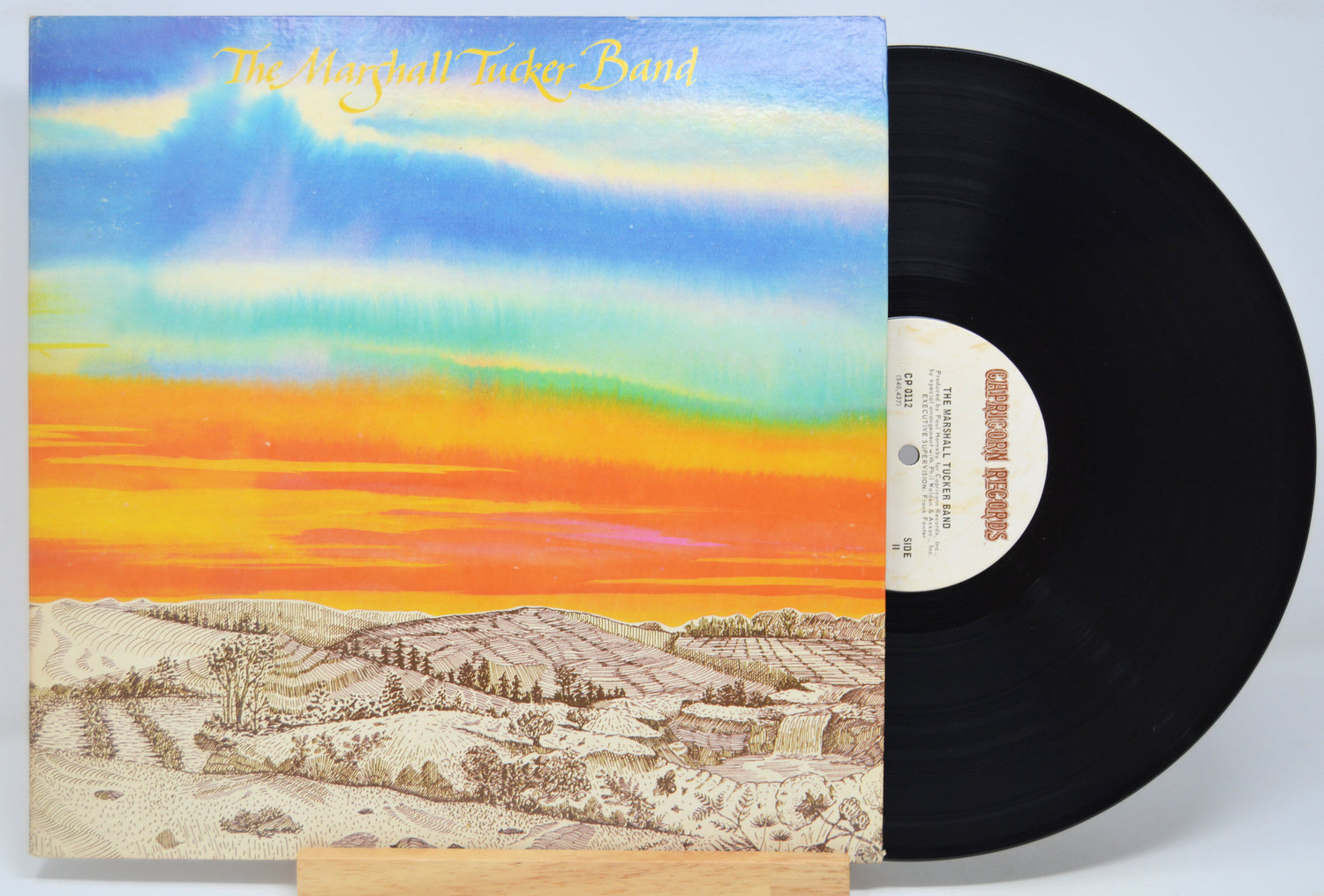 Vinyl record with a colorful album cover featuring a landscape and 'The Marshall Tucker Band' text.
