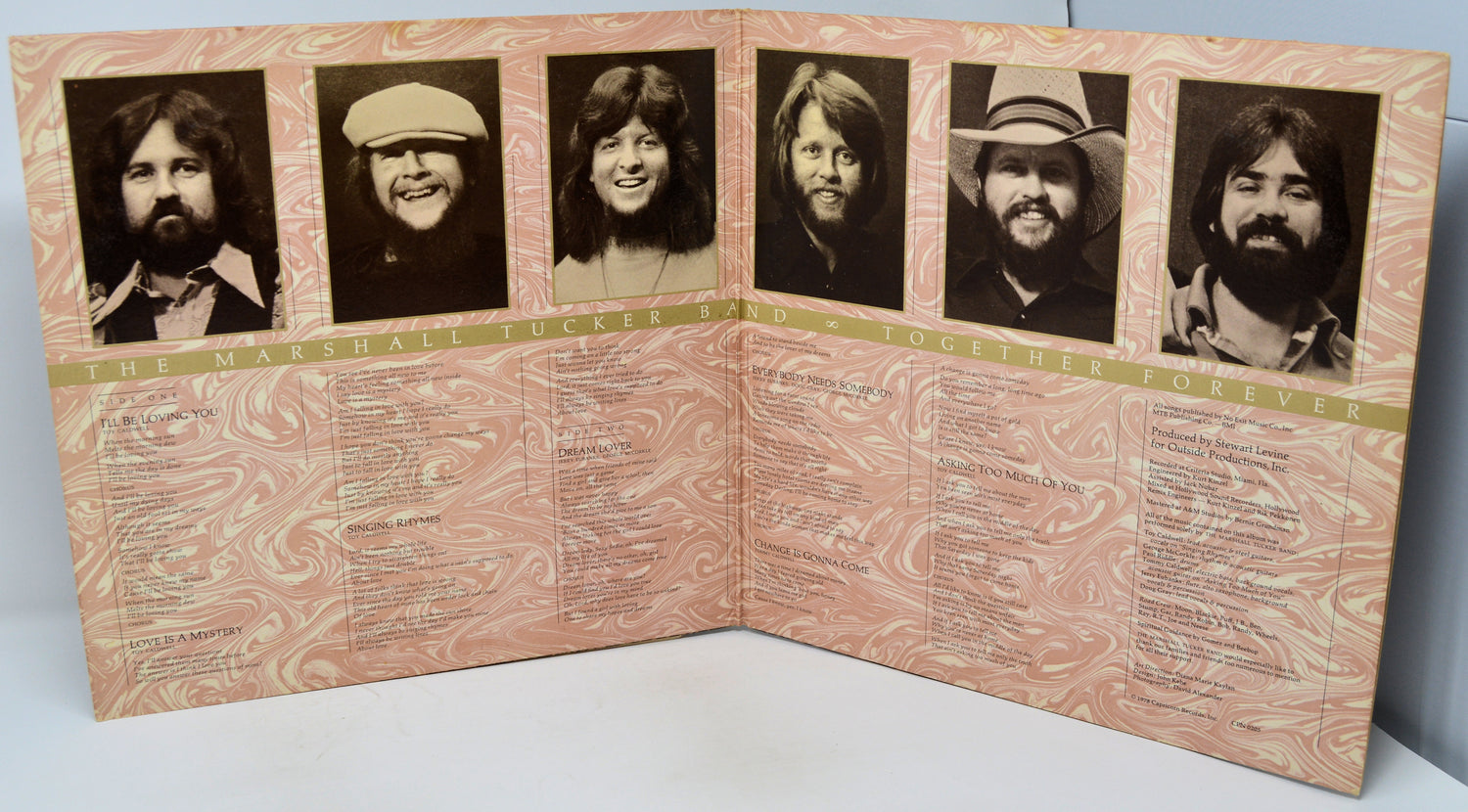 Foldout album cover with black and white portraits and text on a light background