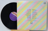 Vinyl record with colorful sleeve on a white background