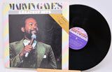 Vinyl record with cover featuring a man holding a microphone, on a white background