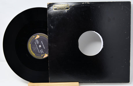 Vinyl record with a white label on a black sleeve, displayed on a stand.