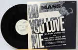 Vinyl record with 'Do You Love Me' album cover featuring text and graphics.