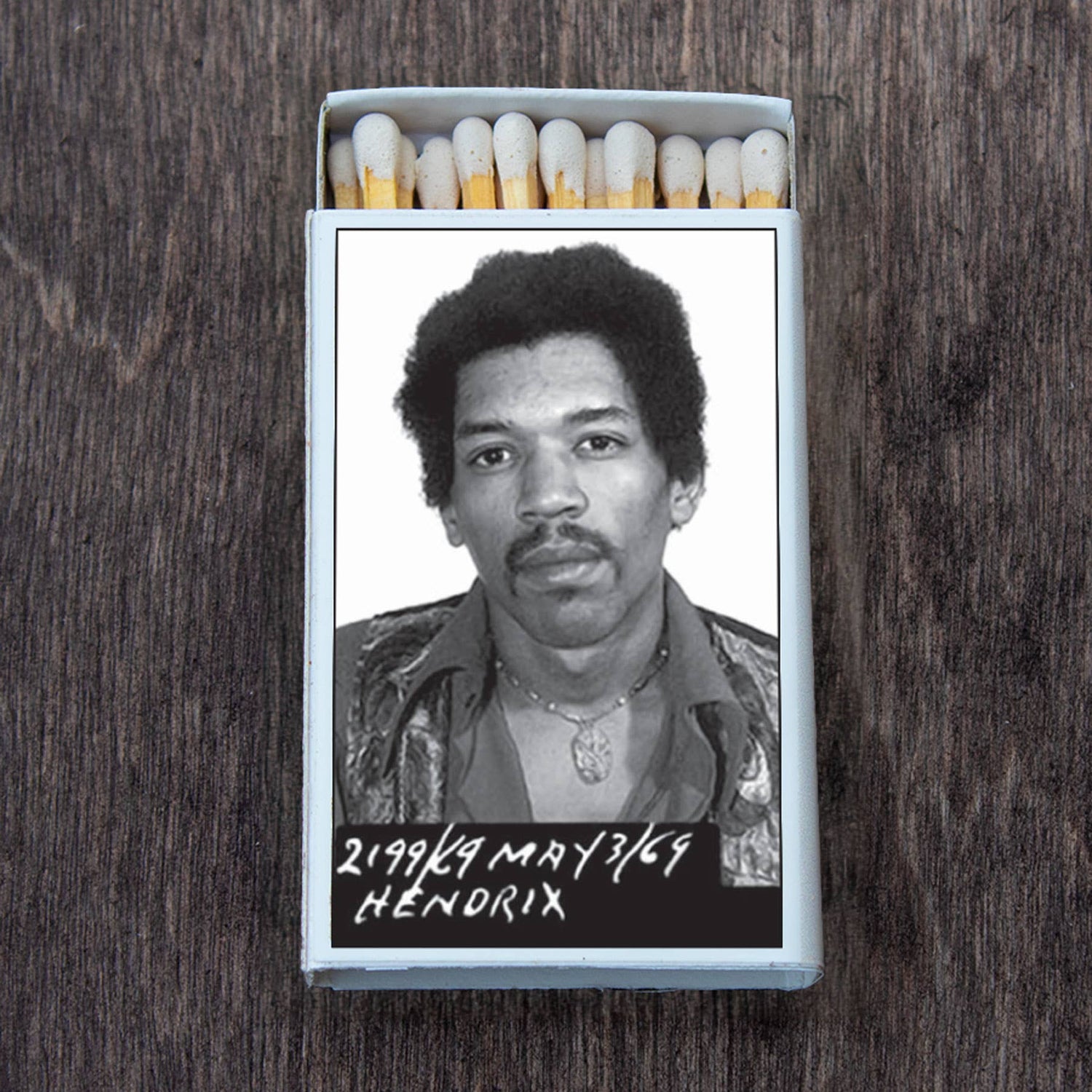 Open matchbox with iconic black and white photo of a famous musician on the cover.