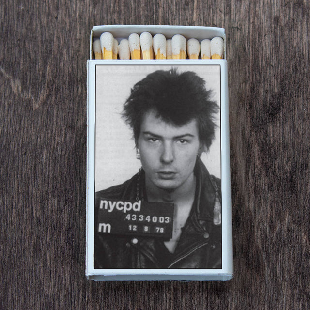 Matchbox with black and white photo of a punk rocker in leather jacket on wooden surface
