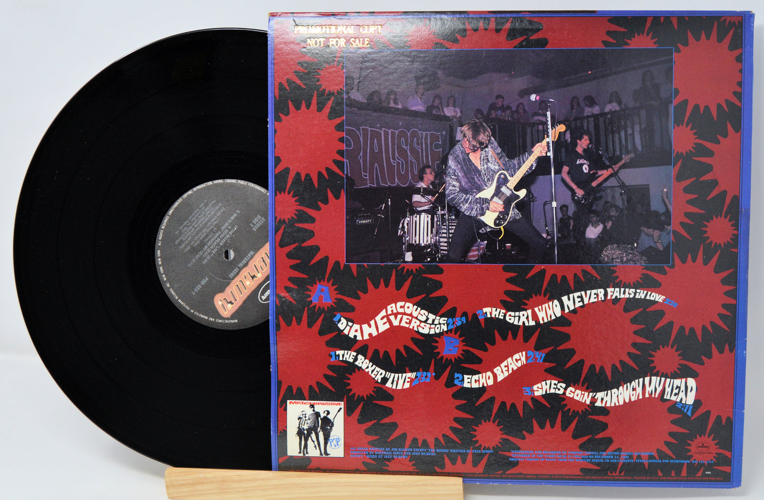 Vinyl record with a colorful cover featuring a band performing.