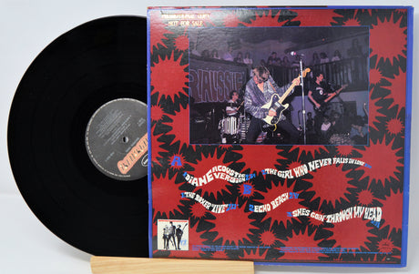 Vinyl record with a colorful cover featuring a band performing.