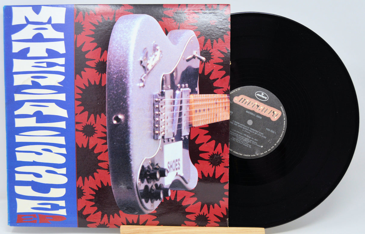 Vinyl record with a guitar illustration on the cover and a visible label.