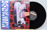 Vinyl record with a guitar illustration on the cover and a visible label.