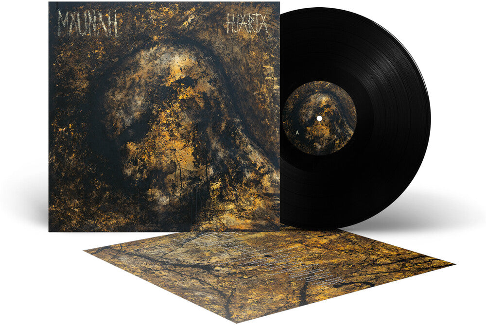 Vinyl record album shown with the black LP partially out of its sleeve and a printed cover insert laid in front. The artwork is dark brown, black, and gold with the text 'MAUNAH' and 'HJARTA' visible on the sleeve.