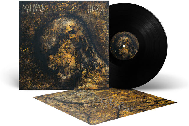 Vinyl record album shown with the black LP partially out of its sleeve and a printed cover insert laid in front. The artwork is dark brown, black, and gold with the text 'MAUNAH' and 'HJARTA' visible on the sleeve.