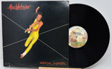 Vinyl record with cover featuring a person in yellow jumpsuit against a black background, labeled 'Max Webster Universal Juniniles'.