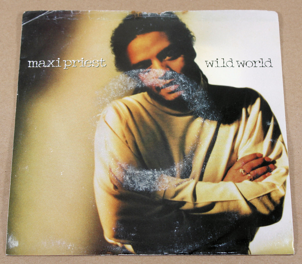 Front cover of Maxi Priest Wild World 7-inch single with colored portrait artwork