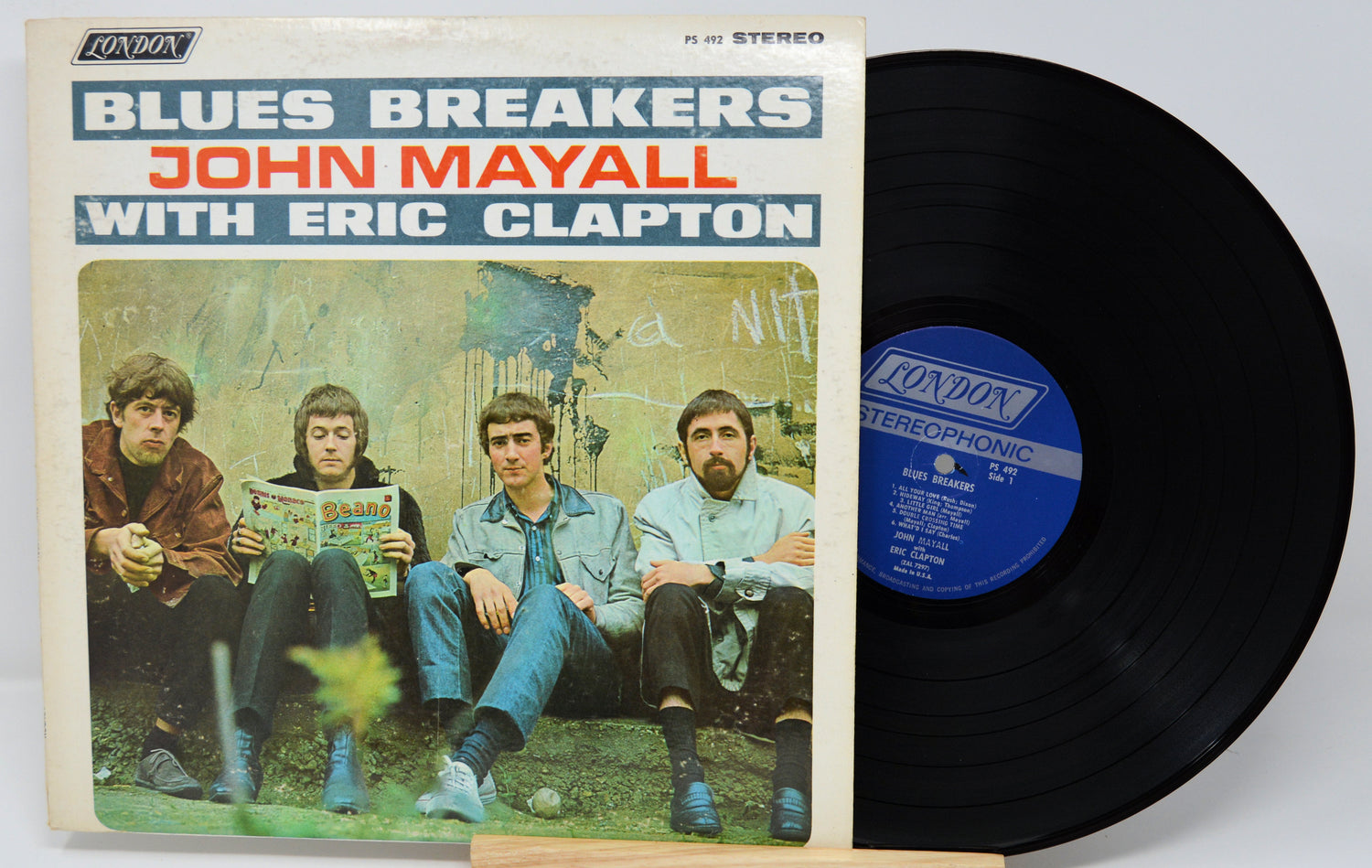 Vinyl record with cover featuring 'Blues Breakers' by John Mayall with Eric Clapton on a white background