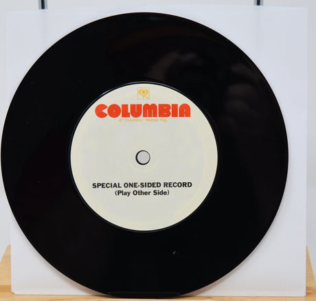 Black vinyl record with a Columbia label on a white background