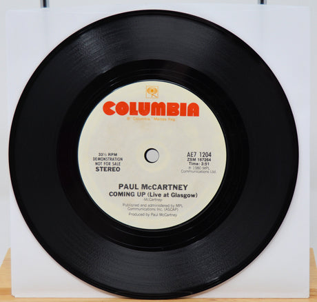 Vinyl record with Columbia label and Paul McCartney's album 'Coming Up (Live at Glasgow)' on a white background
