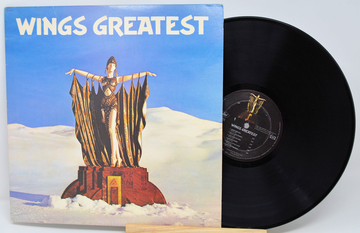 Vinyl record with cover titled 'Wings Greatest' featuring a statue on a cloud.
