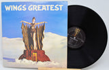 Vinyl record with cover titled 'Wings Greatest' featuring a statue on a cloud.
