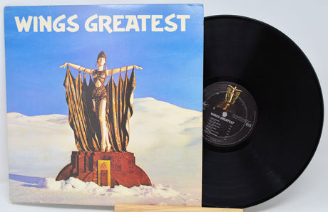 Vinyl record with cover titled 'Wings Greatest' featuring a statue on a cloud.